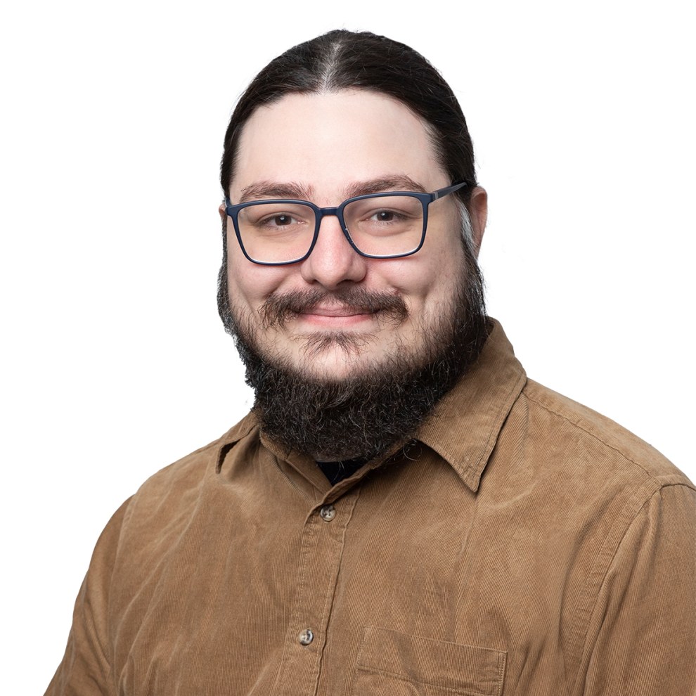 Portrait of Arash Badie-Modiri smiling with a white background.